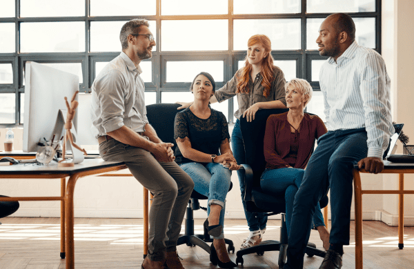 Group of professionals collaborating on global talent management in a modern office